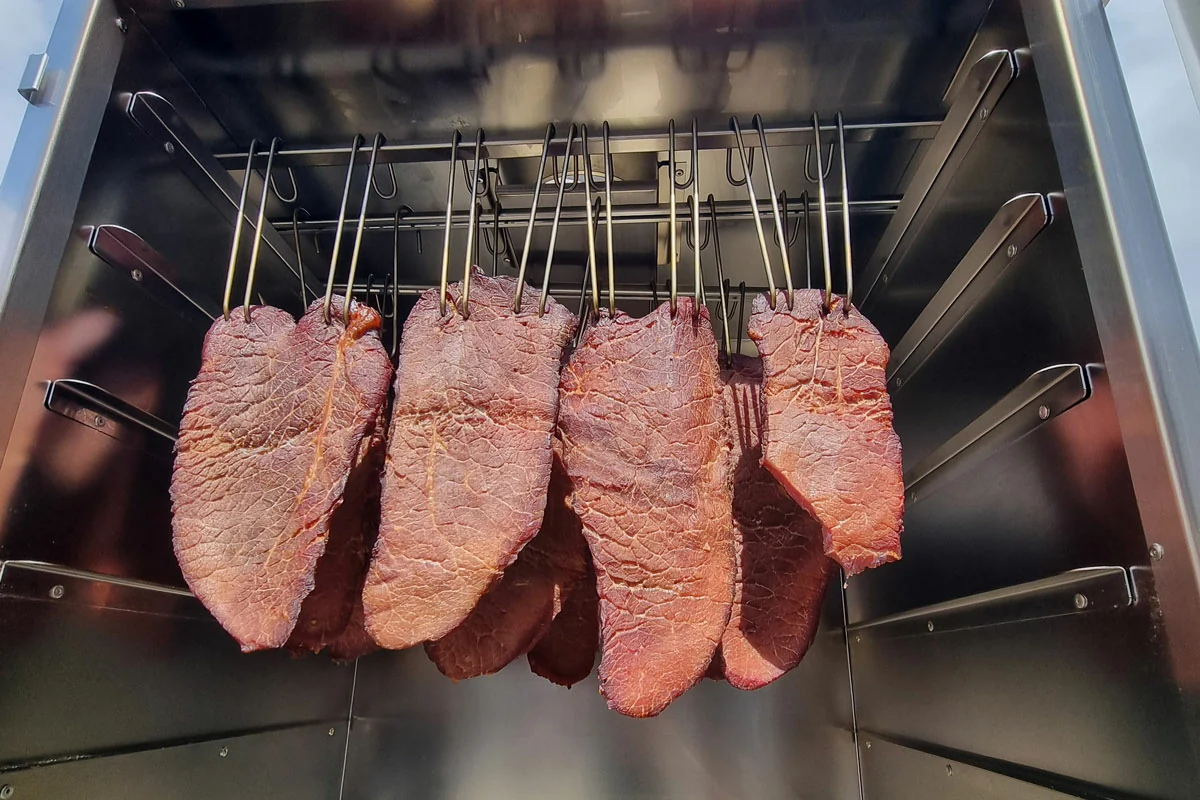 Pieces of jerky drying on a rack