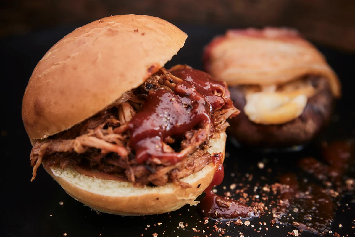 Pulled pork sandwich with BBQ sauce as an example of low and slow cooking