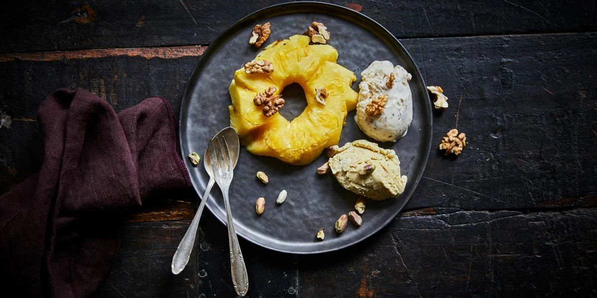 Smoked pineapple served with ice cream and nuts
