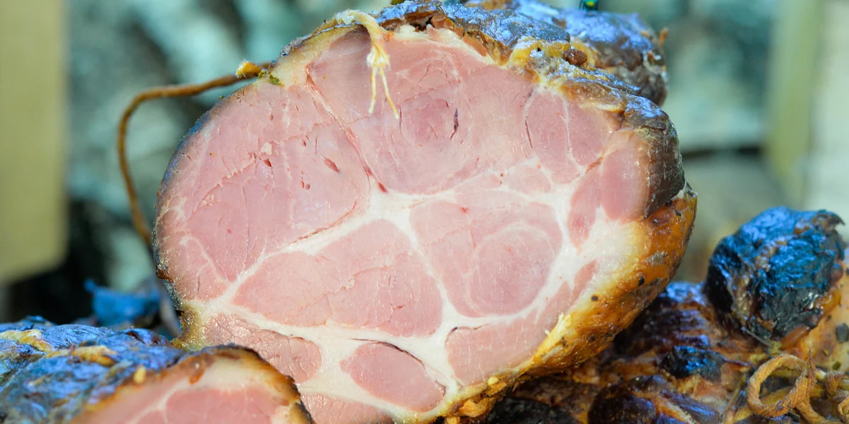 Smoked pork neck sliced to show the centre of the meat